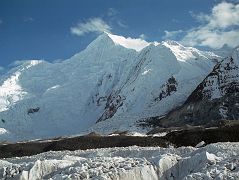 13 Chogolisa Late Afternoon From Shagring Camp On Upper Baltoro Glacier Chogolisa (7665m) is a high snow peak with a distinctive long, almost level summit ridge, seen from Shagring camp on the Upper Baltoro Glacier. Chogolisa I (7665m) is the southwest summit on the left. The slightly lower northeast summit Chogolisa II (7654m) was named Bride Peak by Sir Martin Conway in 1892. In 1909, a party led by Duke of the Abruzzi reached 7500m before being stopped by bad weather. Hermann Buhl and Kurt Diemberger attempted Chogolisa in 1957 after they had successfully summited Broad Peak a few weeks earlier. On June 25 they left camp I and camped in a saddle at 6706m on the southwest ridge. Bad weather forced them to retreat and on June 27 Buhl fell through a cornice and disappeared. His body has never been found.